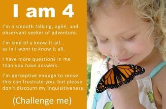 A young girl holding onto a butterfly with the words " i am 4 " written on it.