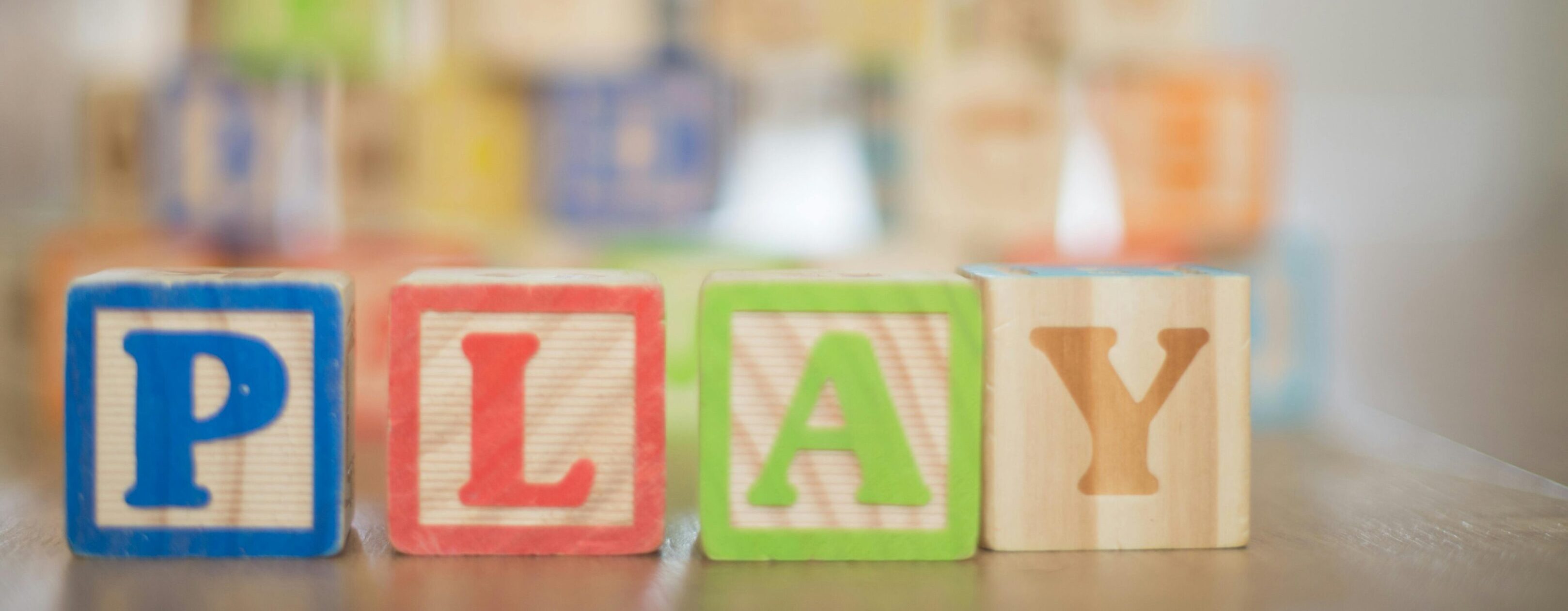 A close up of wooden blocks with the word play written on them